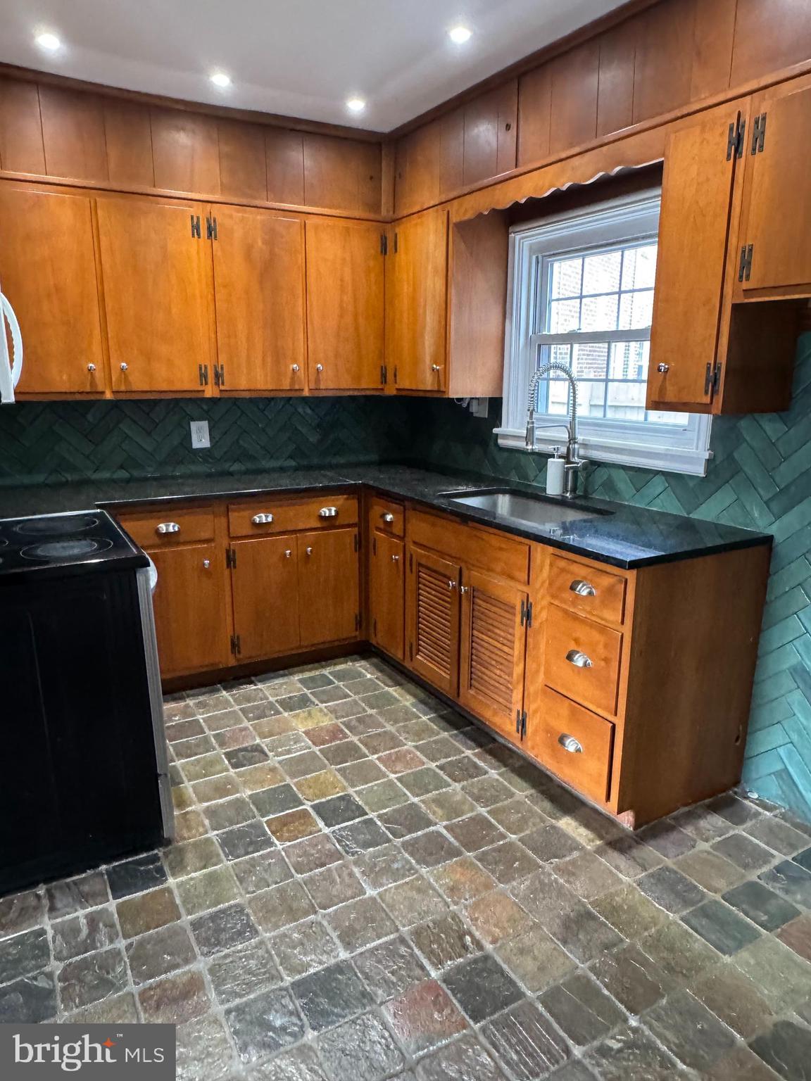102 Harvard Boulevard Reading, PA 19609 - Photo 6 of 11 a kitchen with stainless steel appliances granite countertop a sink and a microwave