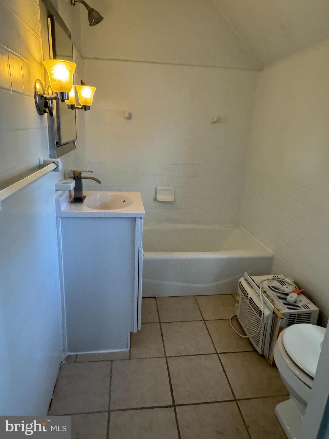 102 Harvard Boulevard Reading, PA 19609 - Photo 8 of 11 a bathroom with a sink a toilet and mirror