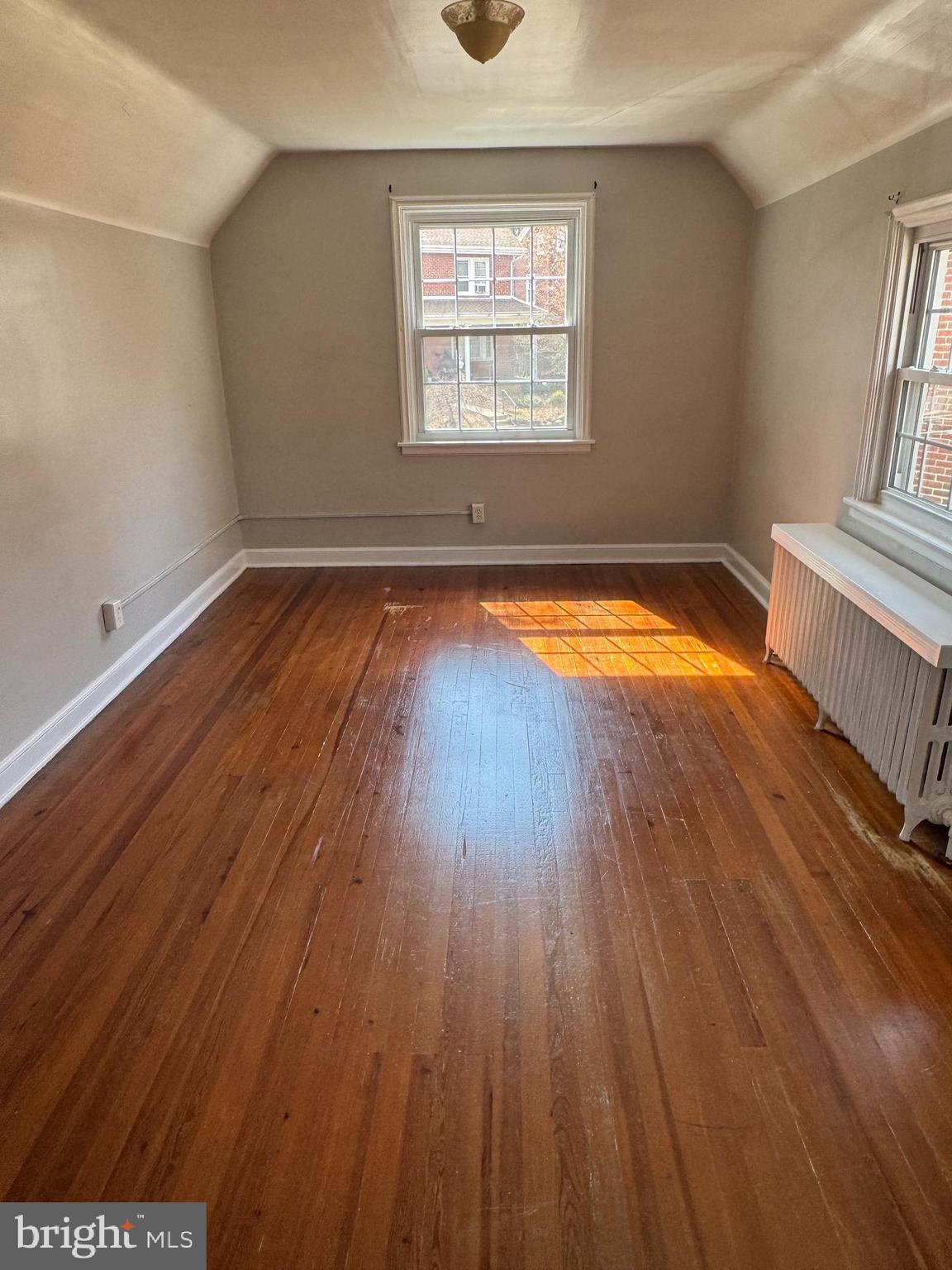 102 Harvard Boulevard Reading, PA 19609 - Photo 9 of 11 an empty room with wooden floor and windows
