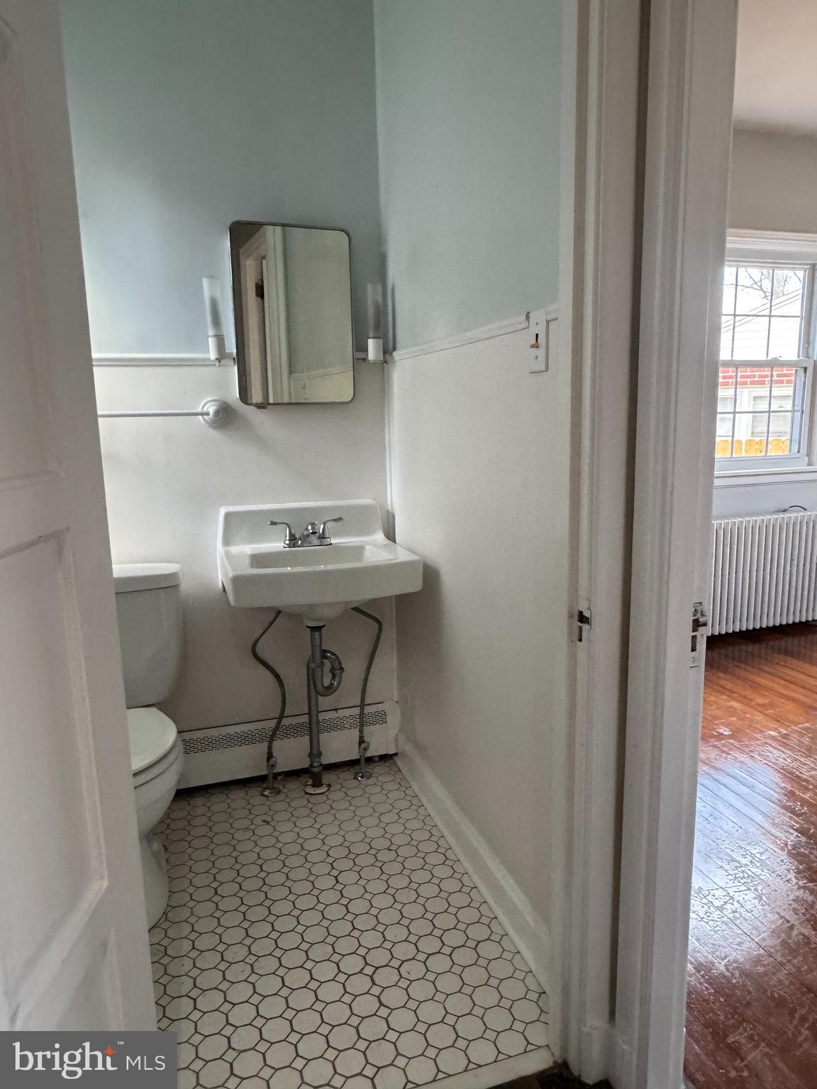 102 Harvard Boulevard Reading, PA 19609 - Photo 10 of 11 a bathroom with a toilet a sink and mirror