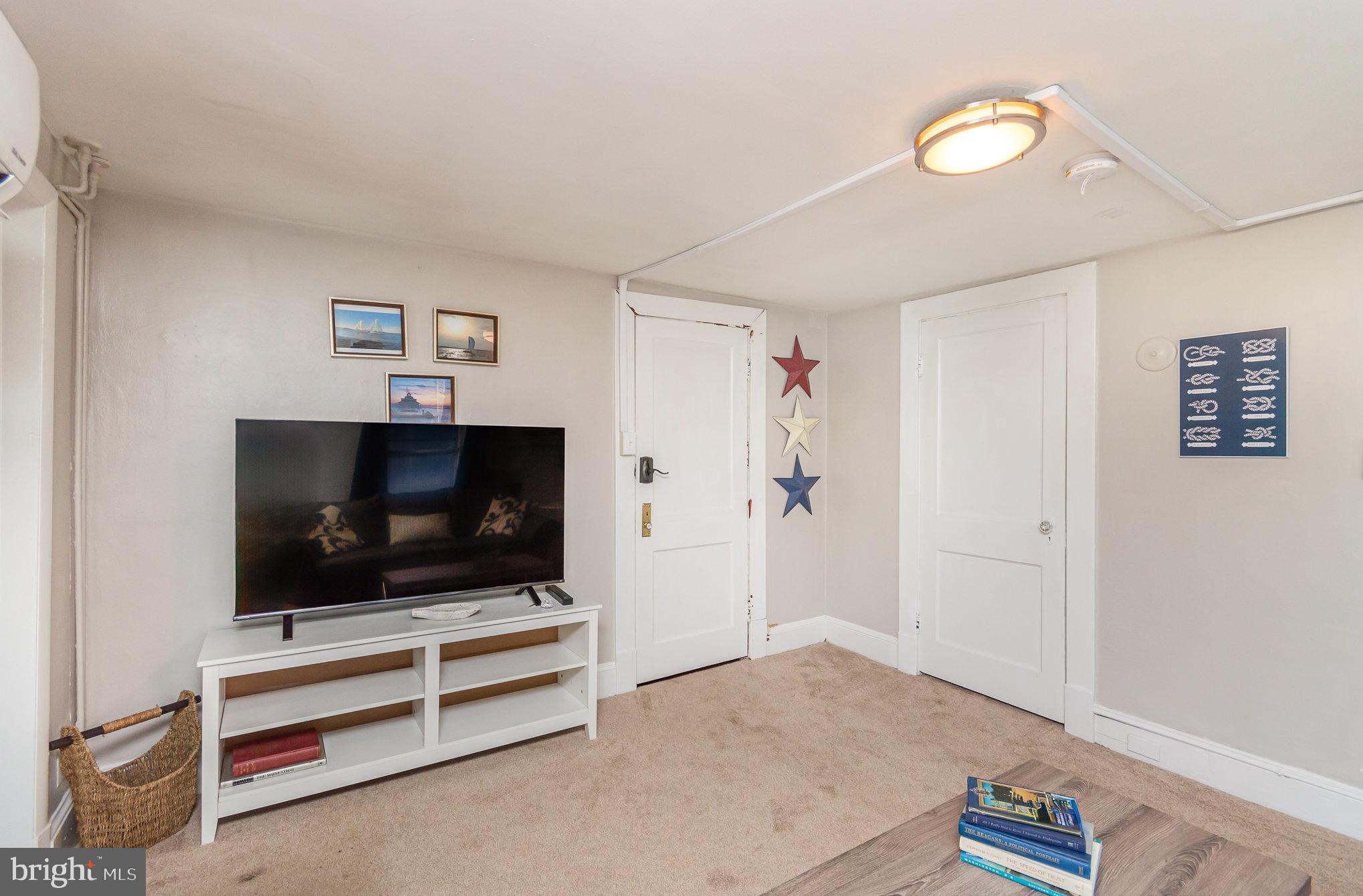 126 Prince George Street, Unit 4 Annapolis, MD 21401 - Photo 2 of 12 a room with furniture and a flat screen tv