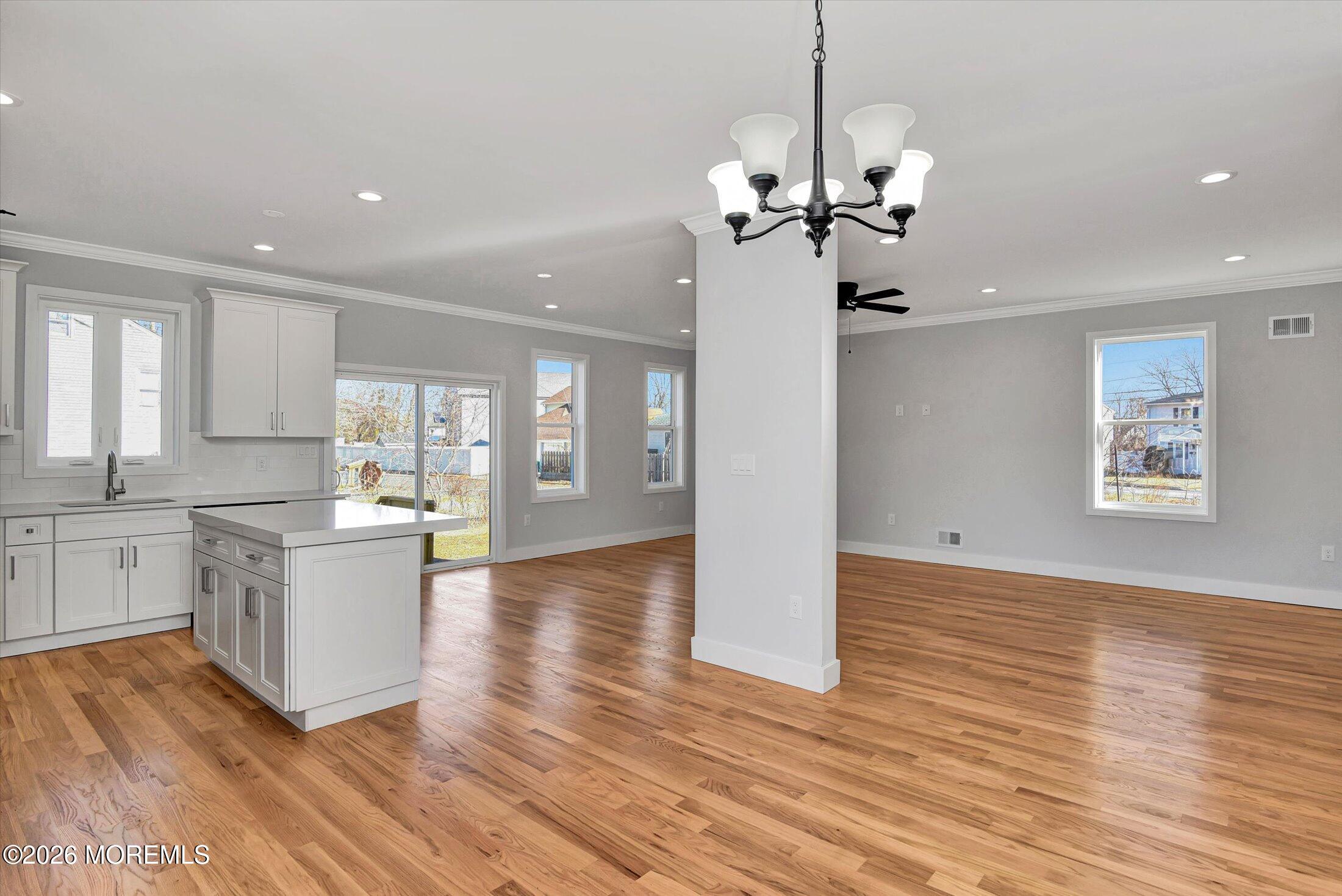 910 Malden Drive Keyport, NJ 07735 - Photo 13 of 38 a large kitchen with chandelier and wooden floor