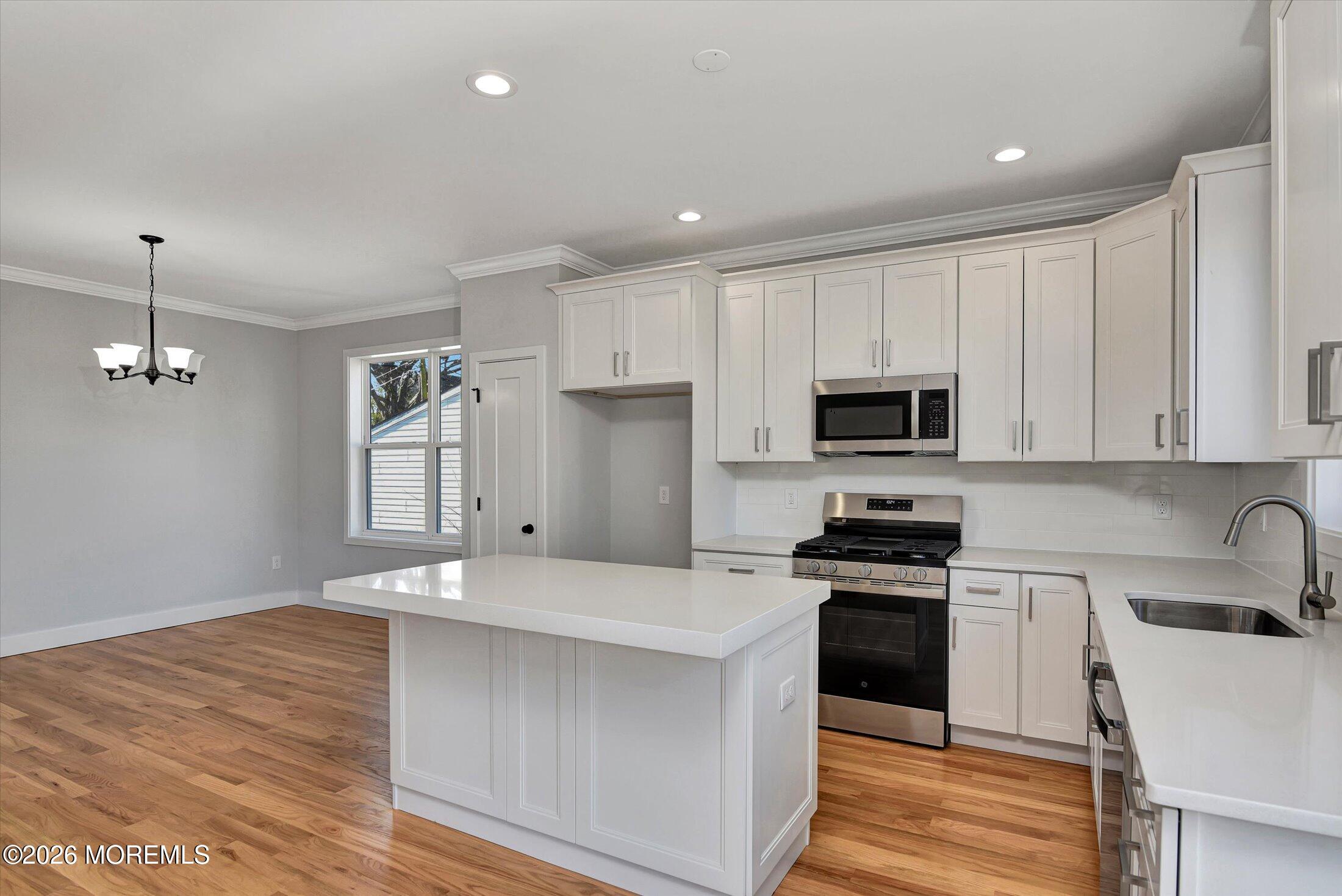 910 Malden Drive Keyport, NJ 07735 - Photo 18 of 38 a kitchen with stainless steel appliances granite countertop a stove a sink and a refrigerator
