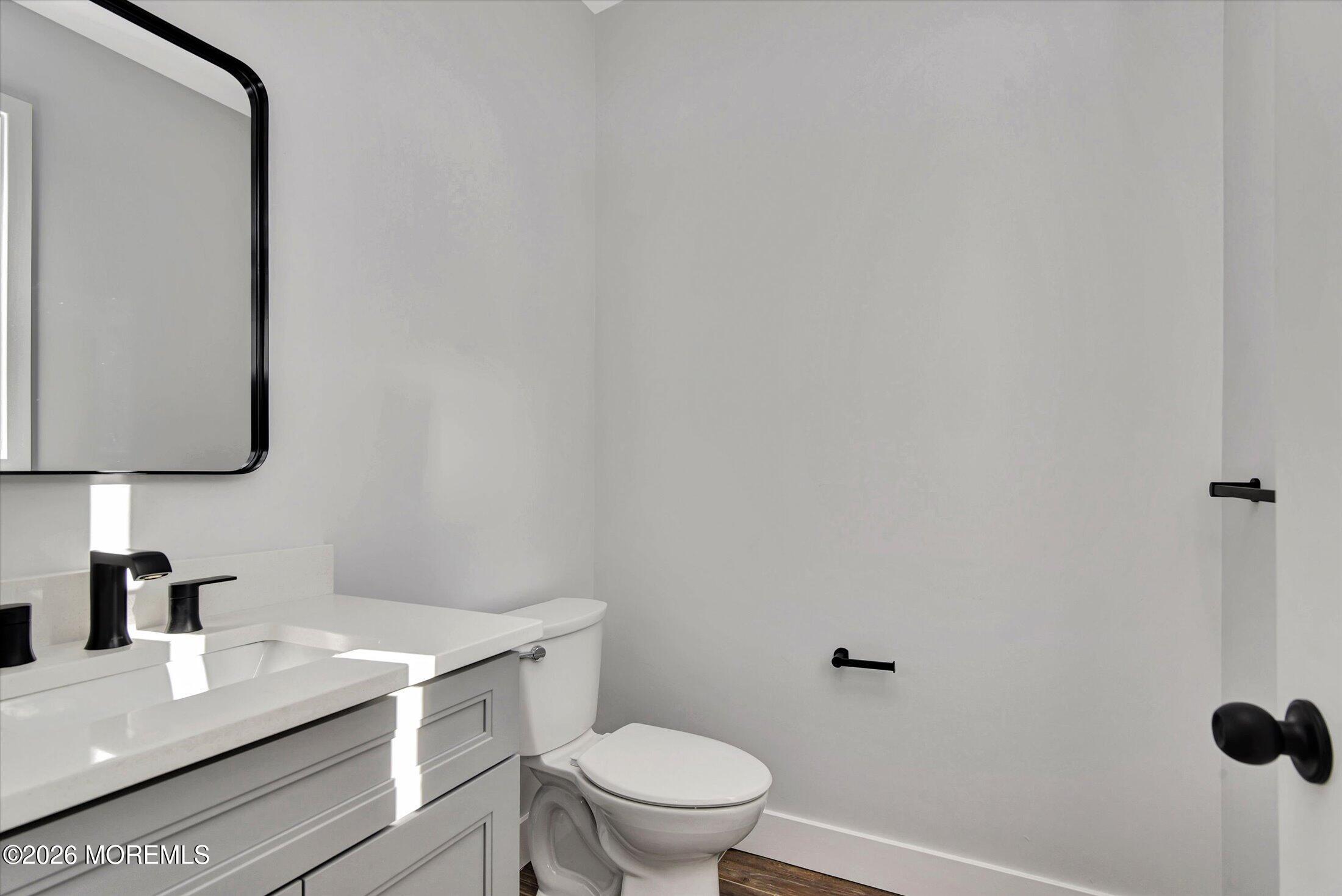 910 Malden Drive Keyport, NJ 07735 - Photo 20 of 38 a bathroom with a granite countertop toilet and a sink