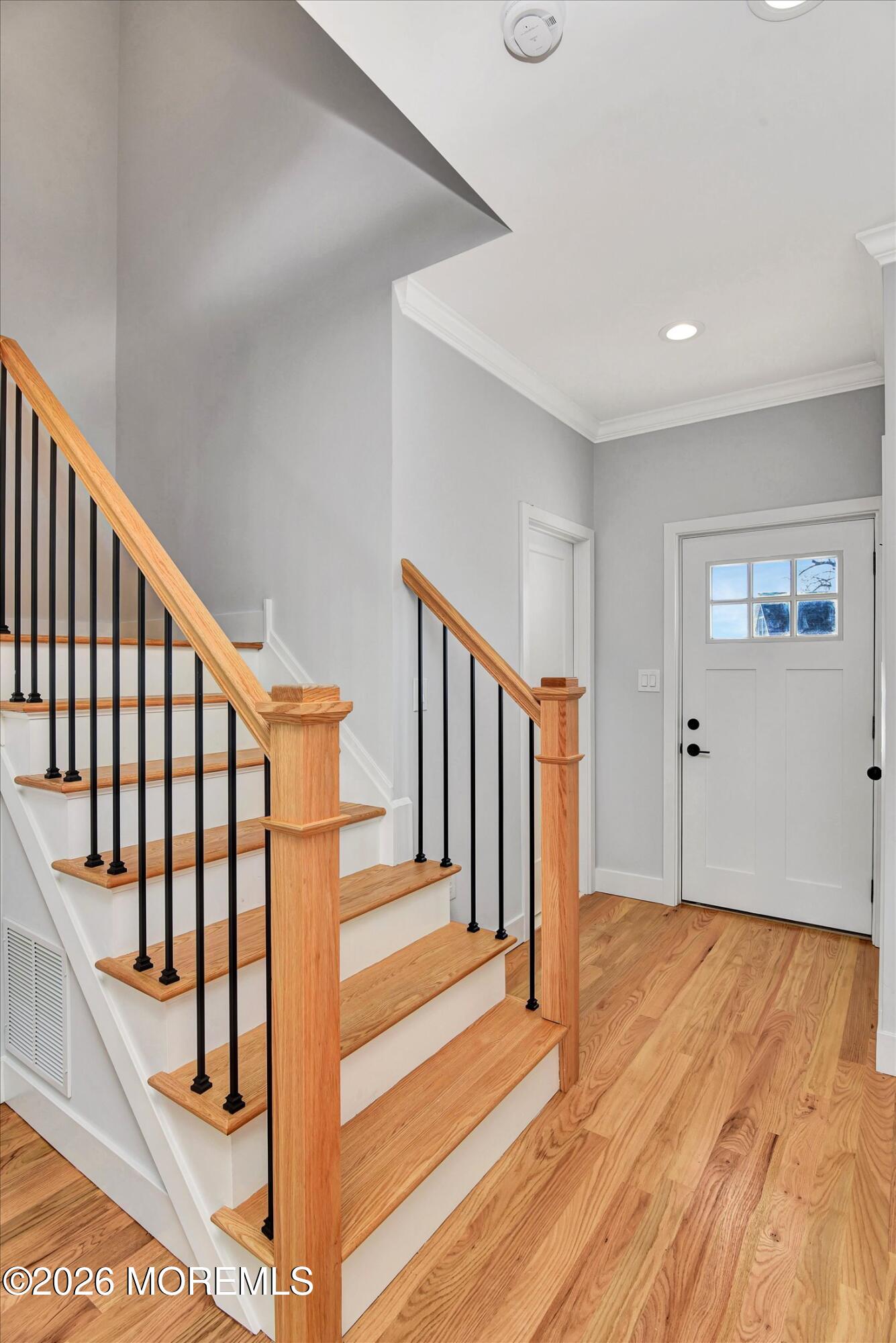 910 Malden Drive Keyport, NJ 07735 - Photo 4 of 38 a view of staircase with lots of frames on wall and wooden floor