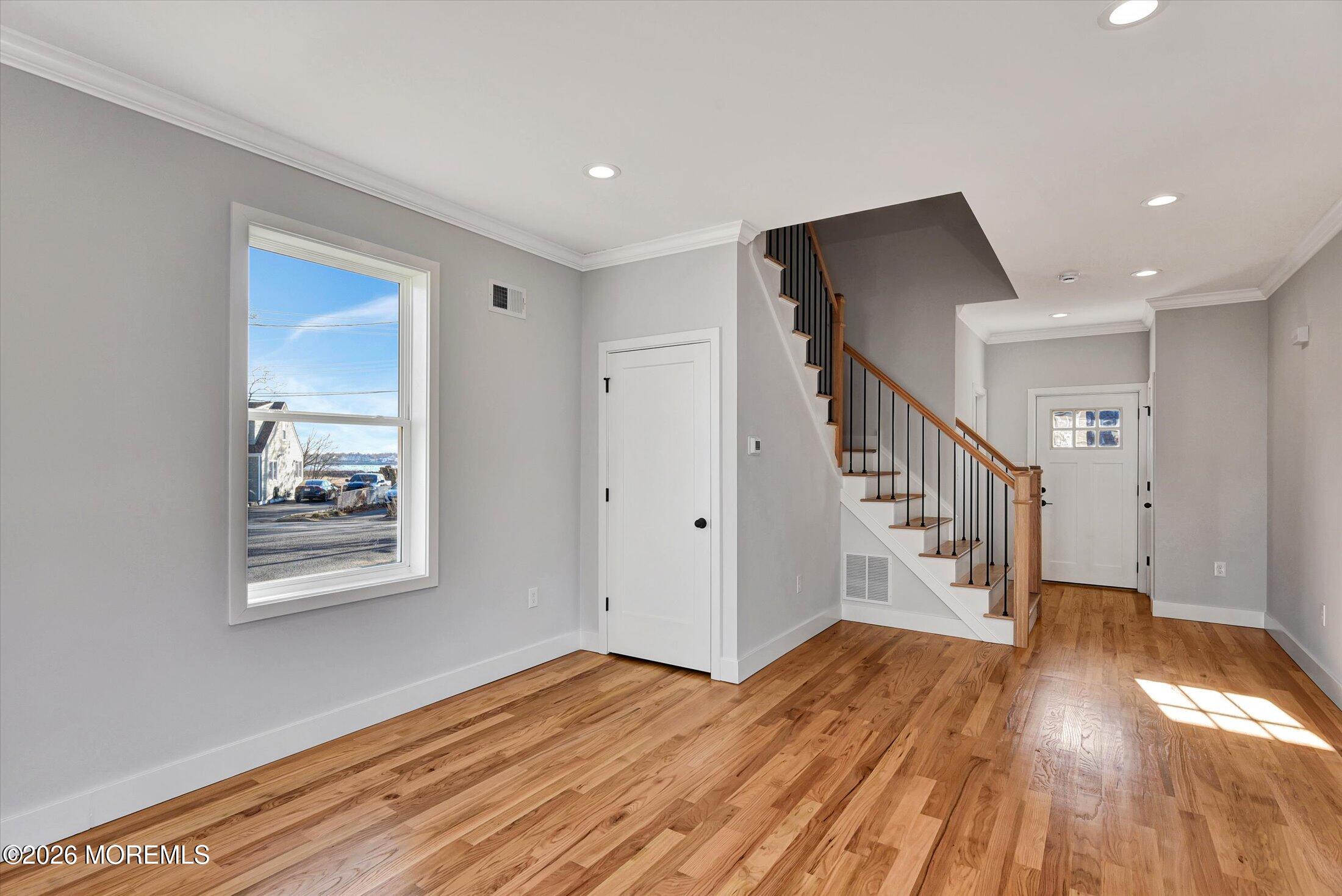 910 Malden Drive Keyport, NJ 07735 - Photo 6 of 38 a view of a hallway with wooden floor and staircase