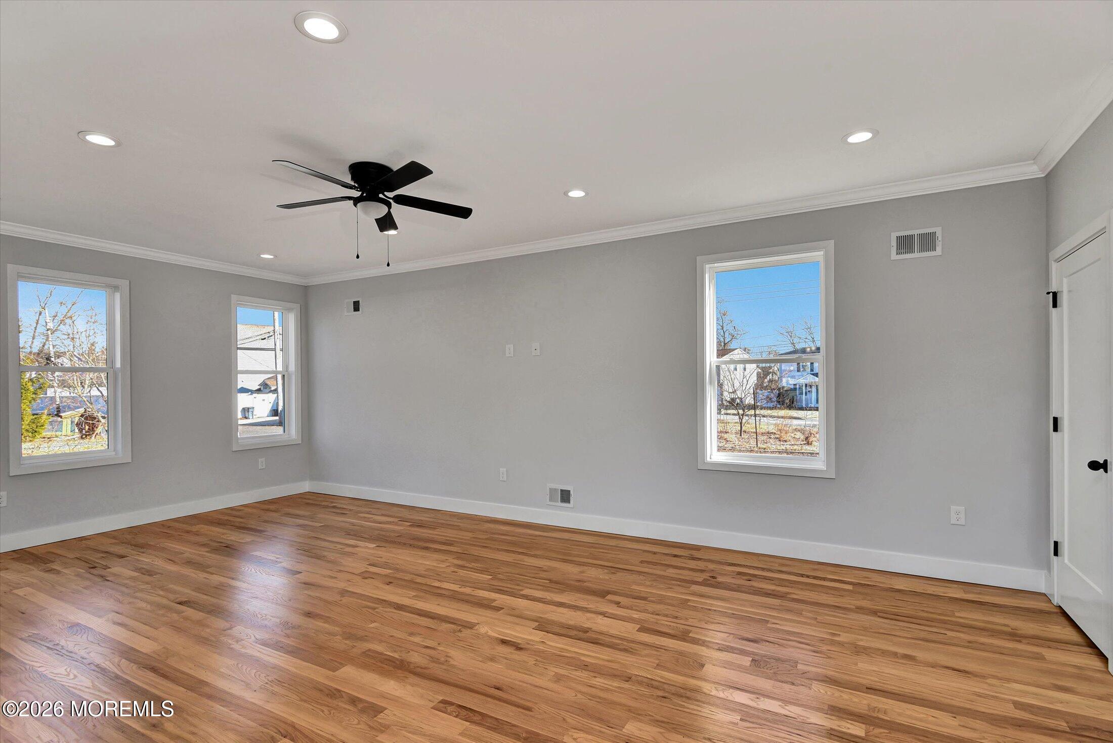 910 Malden Drive Keyport, NJ 07735 - Photo 10 of 38 a view of an empty room with a window and wooden floor