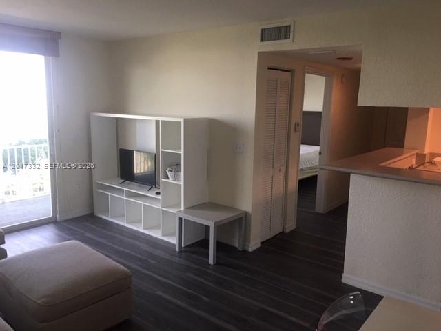 816 Northwest 11th Street, Unit 1104 Miami, FL 33136 - Photo 2 of 7 a room with furniture and a flat screen tv
