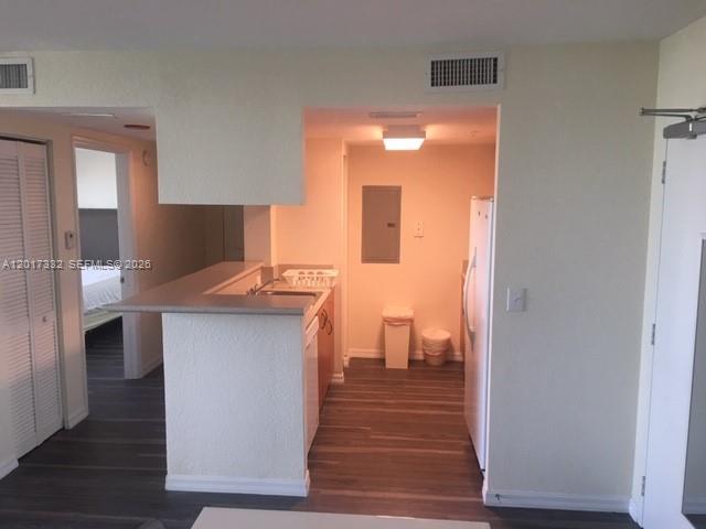 816 Northwest 11th Street, Unit 1104 Miami, FL 33136 - Photo 3 of 7 a kitchen with a refrigerator and a sink