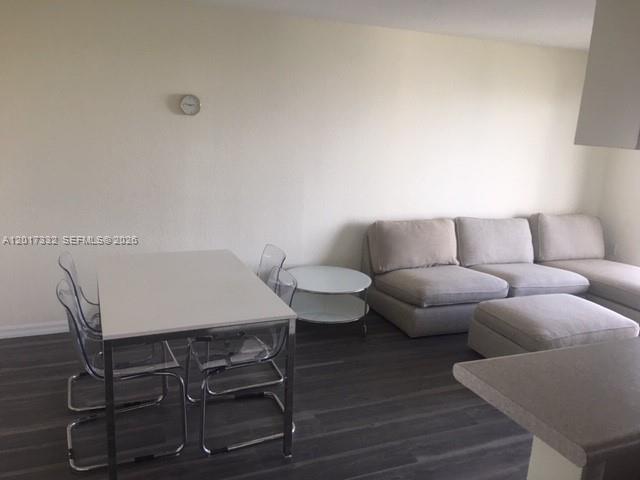 816 Northwest 11th Street, Unit 1104 Miami, FL 33136 - Photo 4 of 7 a living room with furniture a rug and a table