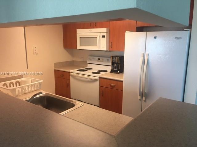 816 Northwest 11th Street, Unit 1104 Miami, FL 33136 - Photo 7 of 7 a kitchen with a refrigerator sink and stove