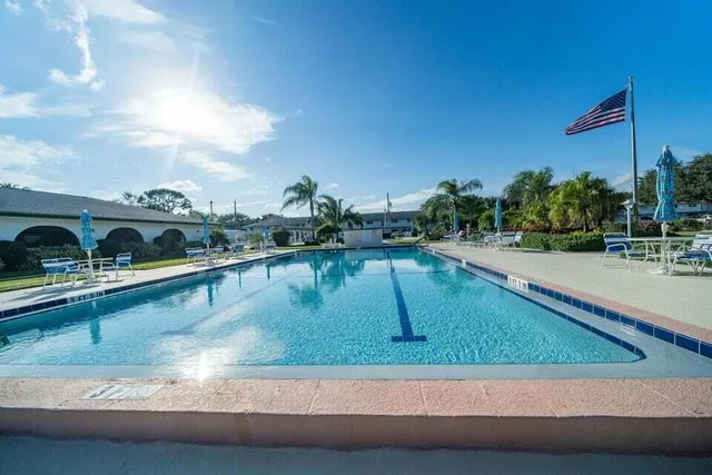 a view of a swimming pool with a yard