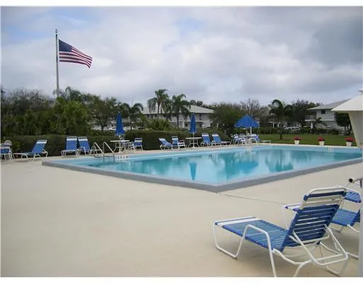 a view of swimming pool with outdoor seating and lake
