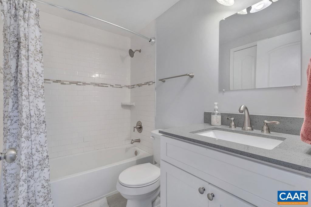 8073 Chestnut Grove Road Esmont, VA 22937 - Photo 15 of 30 a bathroom with a granite countertop sink a toilet and shower
