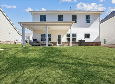a big house with a big yard and potted plants