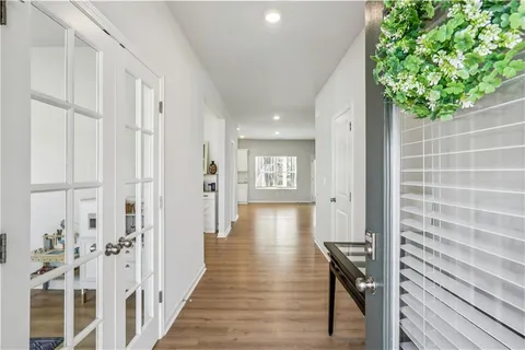 a view of a hallway with wooden floor and staircase