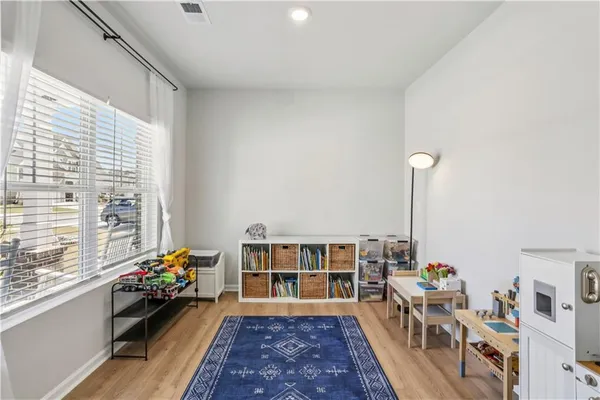 a living room with furniture and a floor to ceiling window