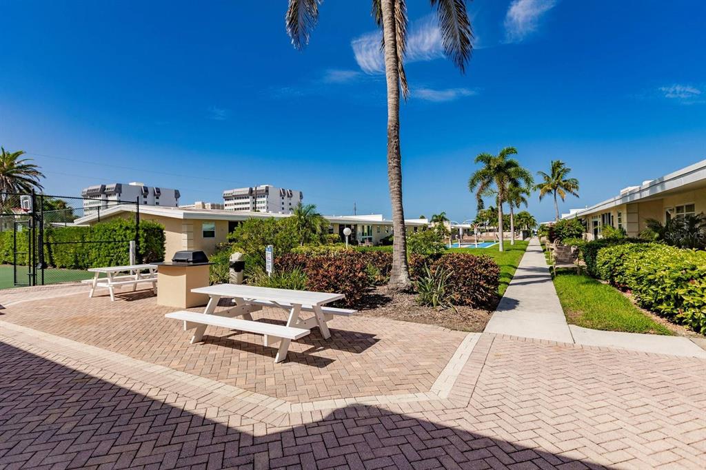 6006 Midnight Pass Road, Unit 10 Sarasota, FL 34242 - Photo 16 of 20 a view of a patio with a table and chairs
