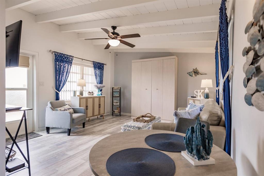 6006 Midnight Pass Road, Unit 10 Sarasota, FL 34242 - Photo 3 of 20 a living room with furniture and a chandelier