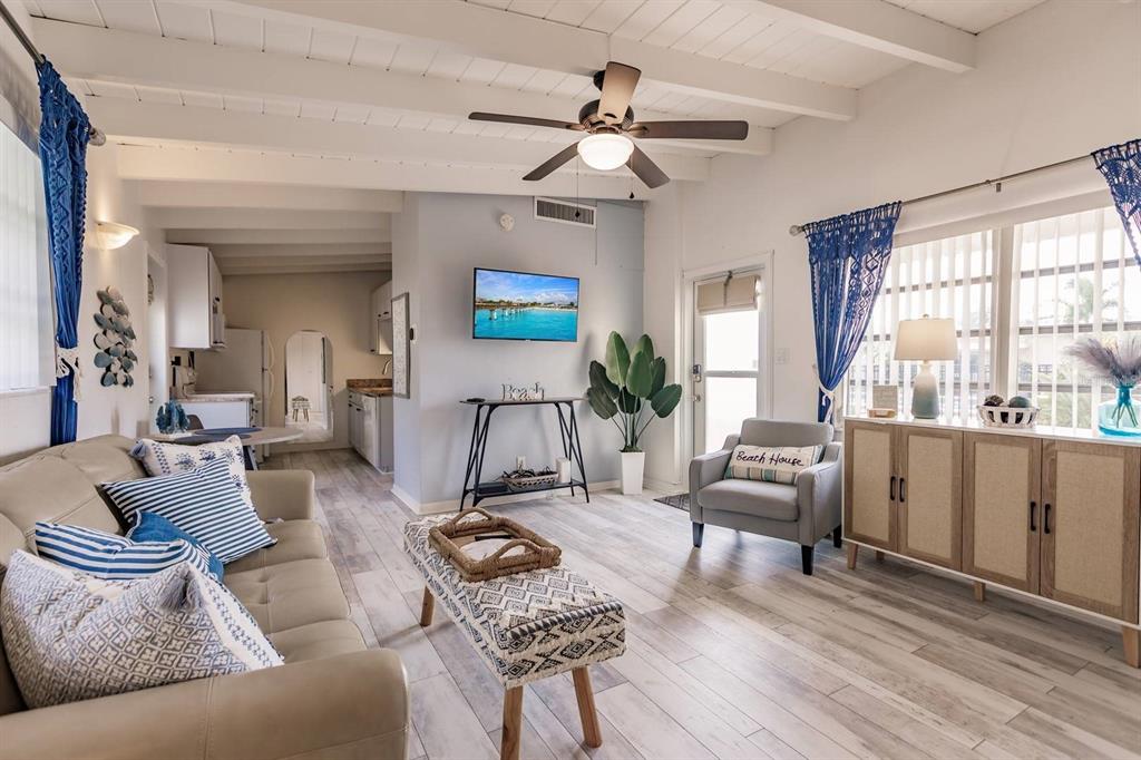 6006 Midnight Pass Road, Unit 10 Sarasota, FL 34242 - Photo 5 of 20 a living room with furniture a ceiling fan and a window