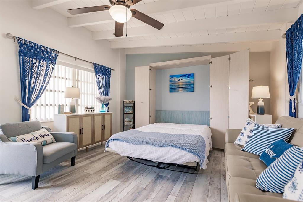 6006 Midnight Pass Road, Unit 10 Sarasota, FL 34242 - Photo 6 of 20 a spacious bedroom with a bed and a couch