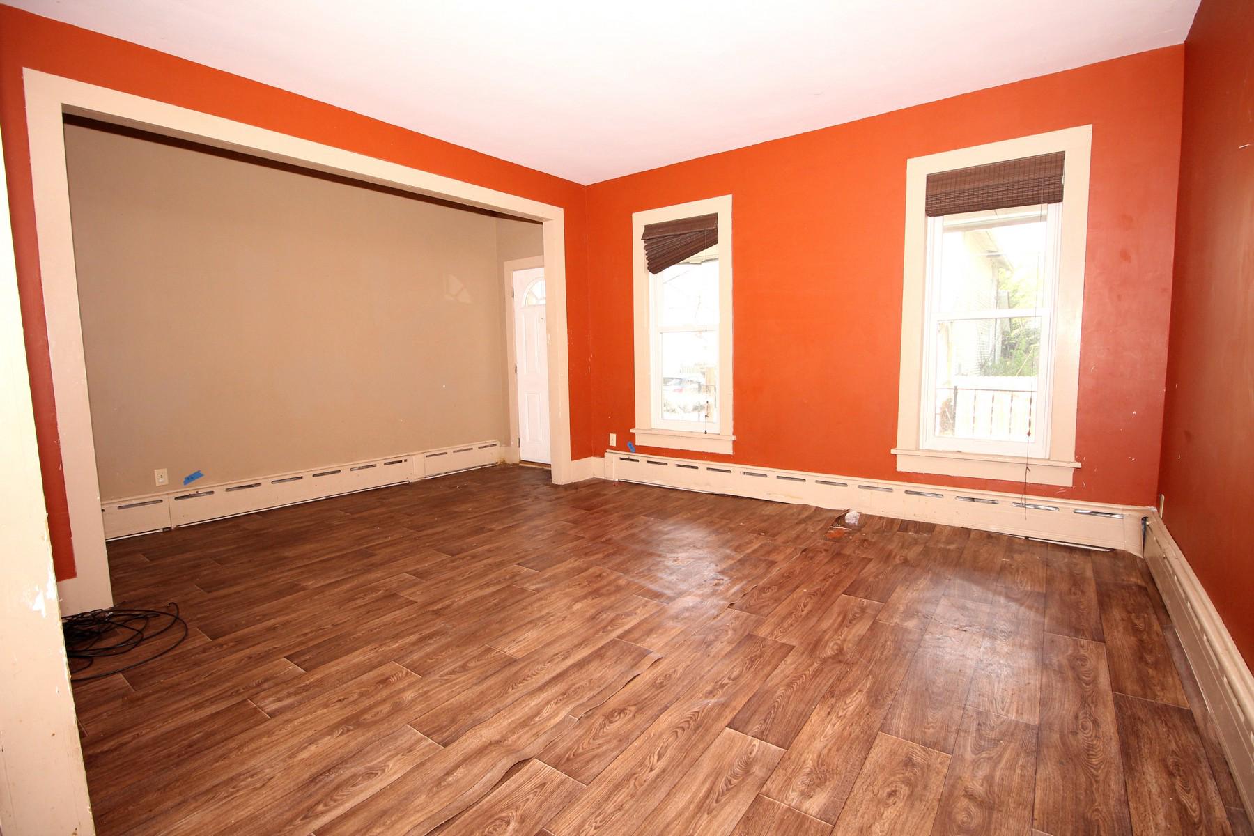 108 Mill Street Lock Haven, PA 17745 - Photo 11 of 26 an empty room with wooden floor and windows