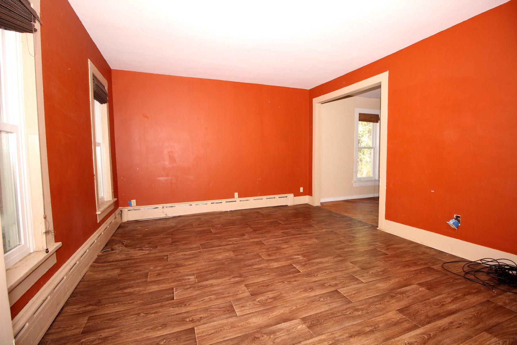 108 Mill Street Lock Haven, PA 17745 - Photo 12 of 26 a view of an empty room with wooden floor and a window