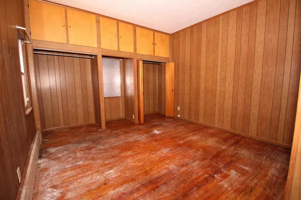 a view of an empty room with wooden walls