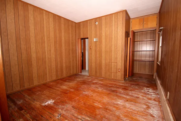 a view of an empty room with wooden walls