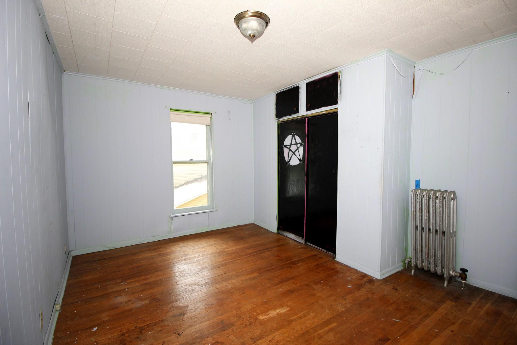 108 Mill Street Lock Haven, PA 17745 - Photo 19 of 26 a view of an empty room with wooden floor and a window