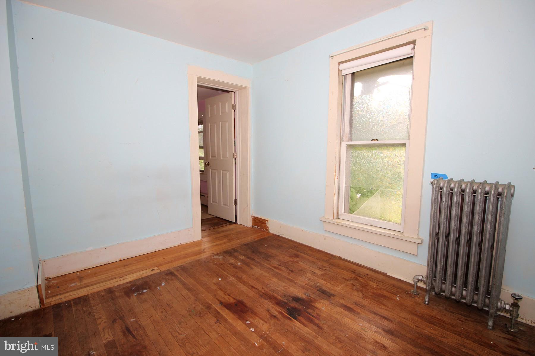 108 Mill Street Lock Haven, PA 17745 - Photo 21 of 26 an empty room with wooden floor and a window