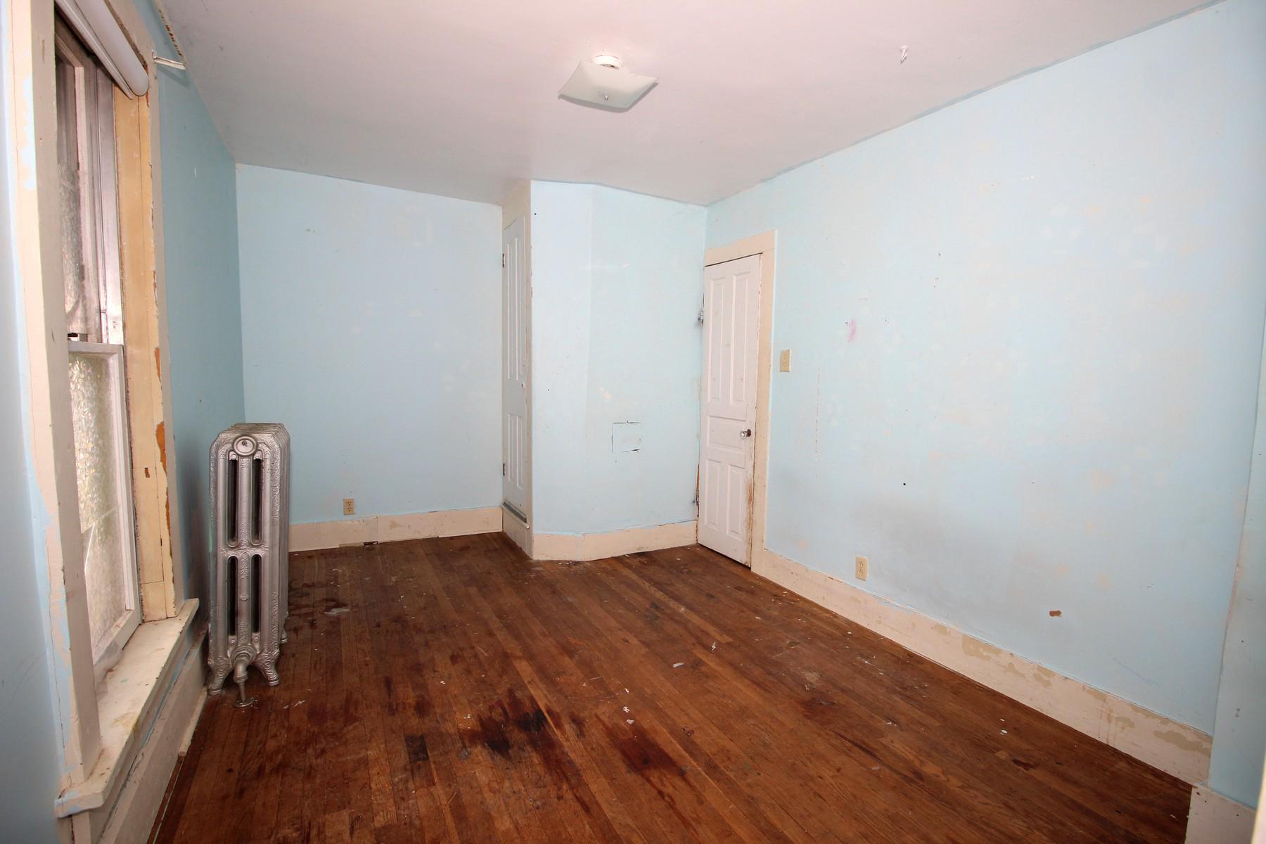 108 Mill Street Lock Haven, PA 17745 - Photo 22 of 26 an empty room with wooden floor and a window