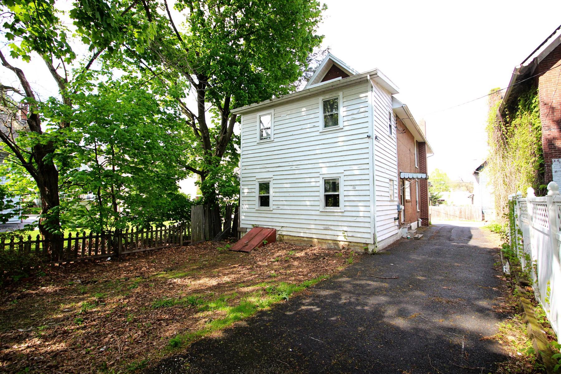 108 Mill Street Lock Haven, PA 17745 - Photo 3 of 26 a view of a house with a small yard and large tree