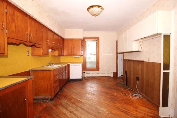 a kitchen with stainless steel appliances a refrigerator and a stove
