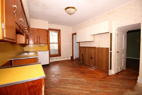 a view of a room with wooden floor and window