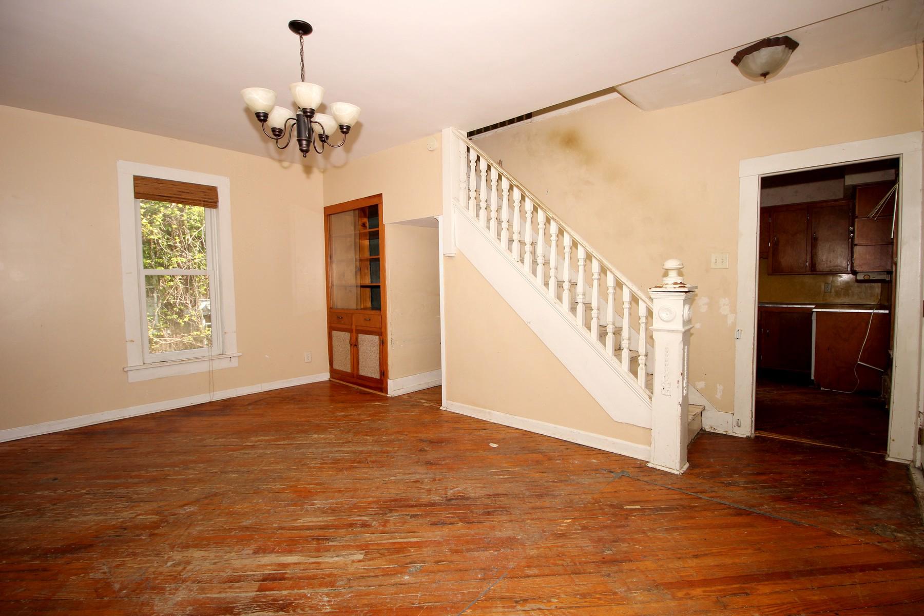 108 Mill Street Lock Haven, PA 17745 - Photo 10 of 26 a view of an empty room with wooden floor and staircase