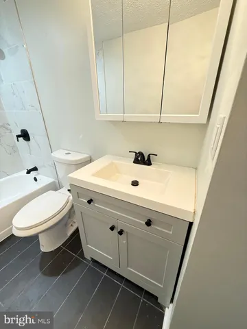 a bathroom with a sink toilet and mirror