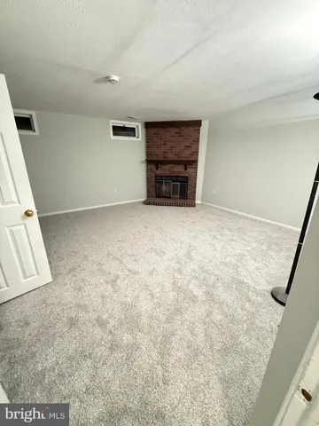 an empty room with furniture and a window