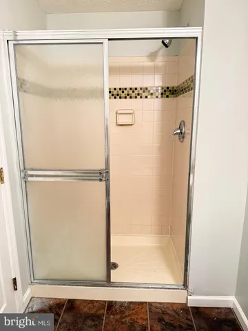 a bathroom with a glass shower door