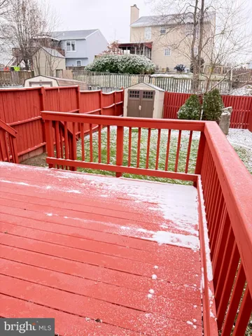 a view of a balcony with wooden floor and fence