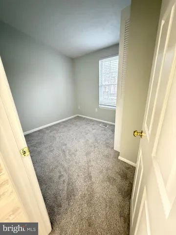 a view of an empty room and a window