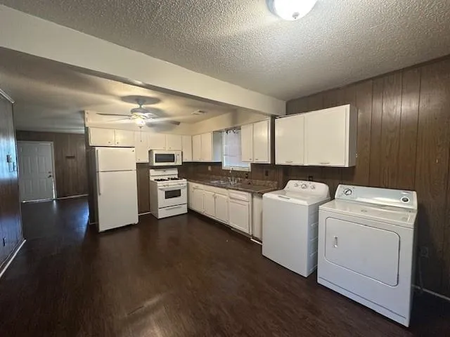 a kitchen with a refrigerator and a stove top oven