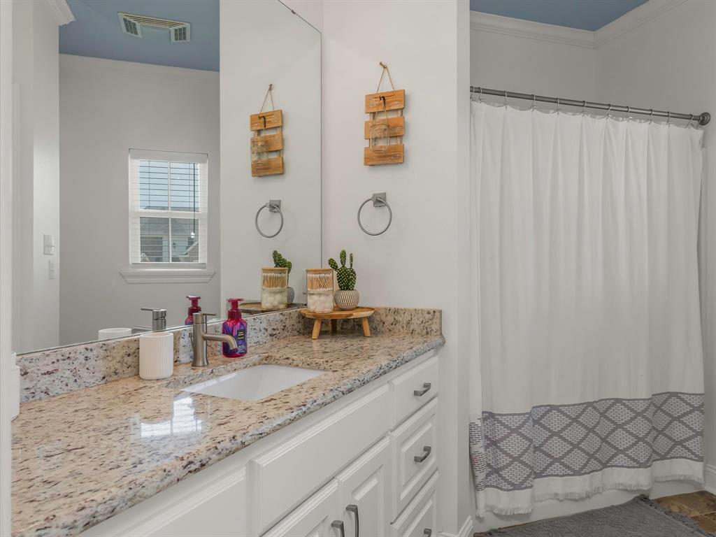 690 Lessie Drive Stonewall, LA 71078 - Photo 25 of 29 Bathroom vanity featuring a light granite countertop with an undermount sink and a polished chrome faucet