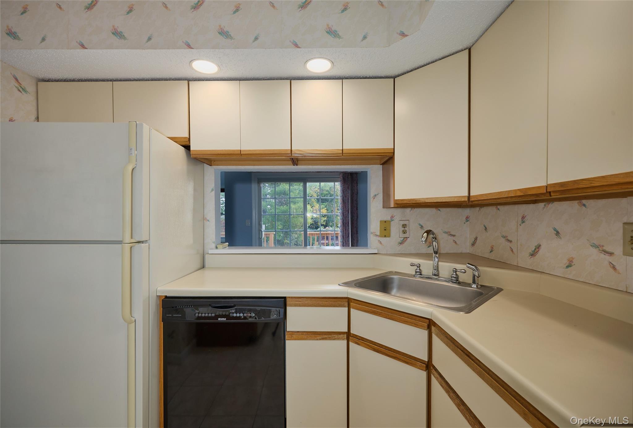 43 Spruce Ridge Drive Fishkill, NY 12524 - Photo 21 of 44 a kitchen with a sink a refrigerator and window