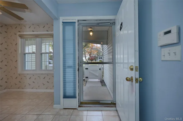 an empty room with windows and fireplace
