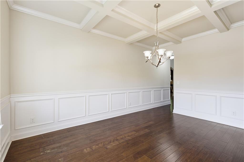 2573 Madison Mae Lane Grayson, GA 30017 - Photo 11 of 51 a view of a chandelier fan and wooden floor