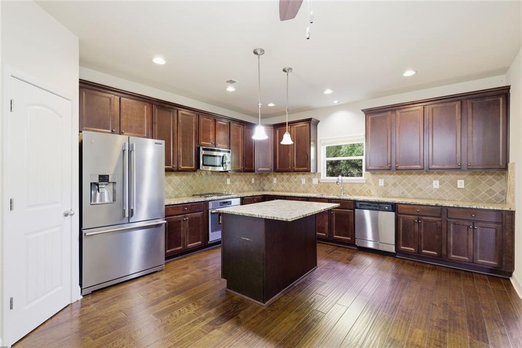 2573 Madison Mae Lane Grayson, GA 30017 - Photo 17 of 51 a large kitchen with wooden floors and stainless steel appliances