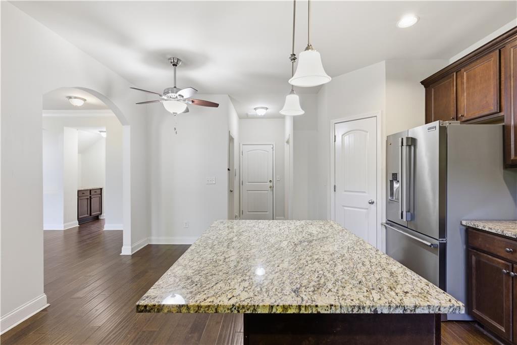 2573 Madison Mae Lane Grayson, GA 30017 - Photo 18 of 51 a kitchen with kitchen island a refrigerator and a stove top oven