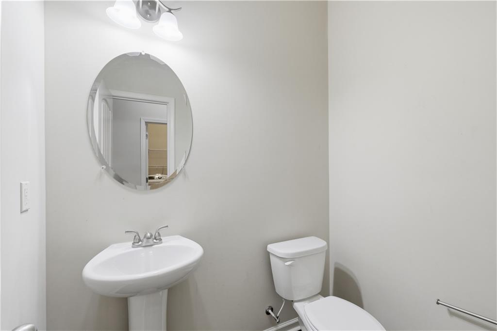 2573 Madison Mae Lane Grayson, GA 30017 - Photo 24 of 51 a bathroom with a toilet sink and mirror