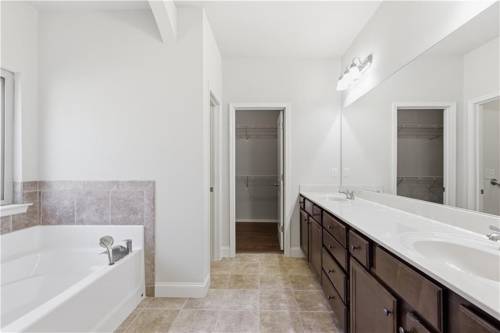 2573 Madison Mae Lane Grayson, GA 30017 - Photo 27 of 51 a bathroom with a tub sink and mirror